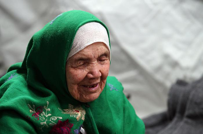 105-year old Afghan regugee Bibihal Uzbeki from Kunduz, Afghanistan, rests in Croatia's main refugee camp at Opatovac, Croatia, near the border with Serbia, Tuesday, Oct. 27, 2015. Centenarian Bibihal Uzbeki, crossed into Croatia on a stretcher from Serbia with a large group of refugees, including her son and several other relatives, among tens of thousands who have traveled across continents, fleeing war and poverty to search for a happier, safer future in Europe. (ANSA/AP Photo/Marjan Vucetic)