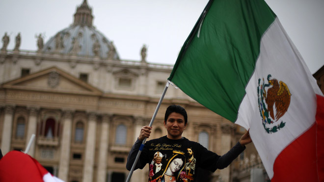 VATICAN CITY, VATICAN - MARCH 17: A boy waves the flag of Mexico in St Peter's Square after Pope Francis gave his first Angelus blessing on March 17, 2013 in Vatican City, Vatican. The Vatican is preparing for the inauguration of Pope Francis on March 19, 2013 in St Peter's Square. (Photo by Peter Macdiarmid/Getty Images)