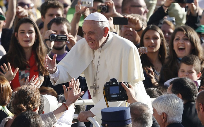 Pope Francis greets the crowd as he arrives to lead his general audience in St. Peter's Square at the Vatican Oct. 23. (CNS photo/Paul Haring) (Oct. 23, 2013) See POPE-AUDIENCE Oct. 23, 2013.
