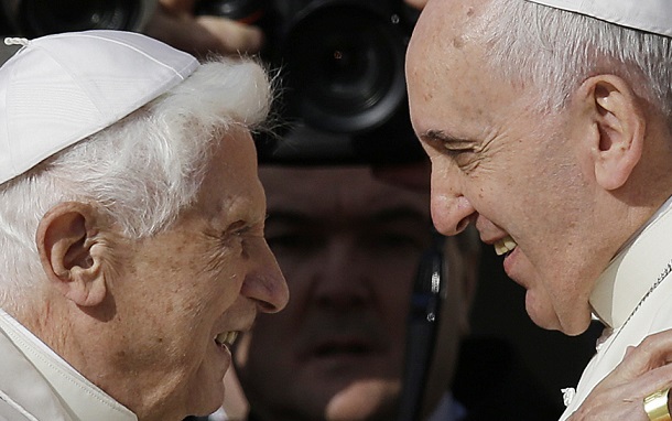 Pope Francis, right, hugs Pope Emeritus Benedict XVI prior to the start of a meeting with elderly faithful in St. Peter's Square at the Vatican, Sunday, Sept. 28, 2014. (AP Photo/Gregorio Borgia)