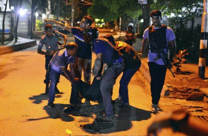 People help an unidentified injured person after a group of gunmen attacked a restaurant popular with foreigners in a diplomatic zone of the Bangladeshi capital Dhaka, Bangladesh, Friday, July 1, 2016. A group of gunmen attacked a restaurant popular with foreigners in a diplomatic zone of the Bangladeshi capital on Friday night, taking hostages and exchanging gunfire with security forces, according to a restaurant staff member and local media reports. (ANSA/AP Photo) [CopyrightNotice: Copyright 2016 The Associated Press. All rights reserved. This material may not be published, broadcast, rewritten or redistribu]