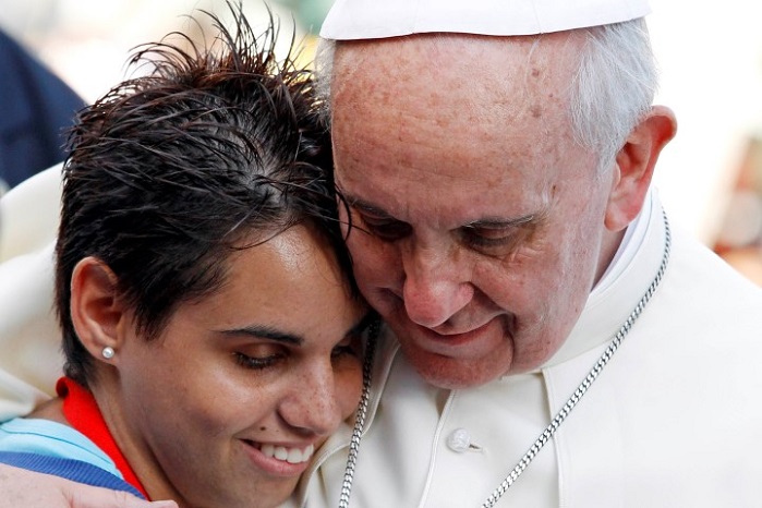 Pope Francis embraces a woman during a meeting with youths in Cagliari